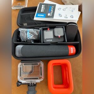 GoPro Action Camera with Black and Red Accessories